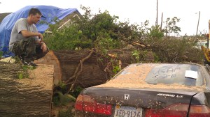 Smashed Honda and chainsaw operator. Tanya Mikulas, photographer