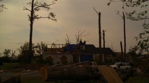 House on Forest Lake Drive being covered with a giant tarp.